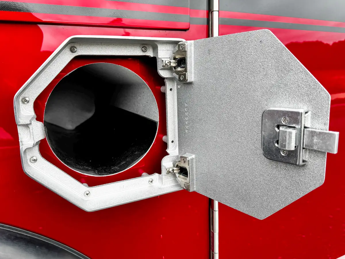 Side compartment interior close-up with shelf and textured wall liner.